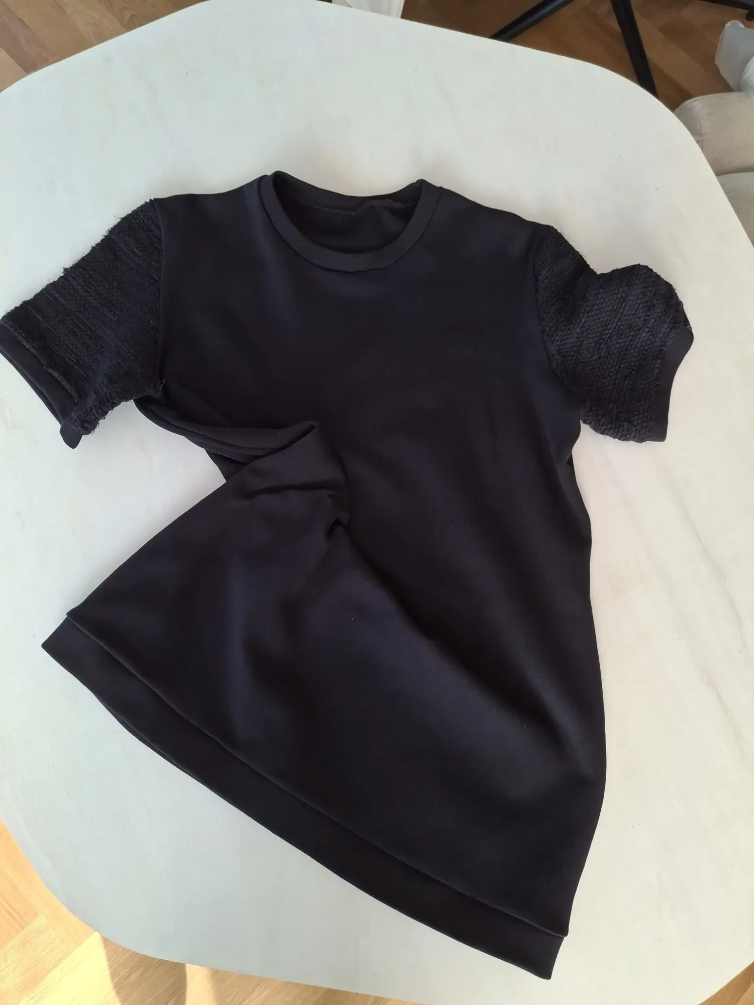 Black Solitaire t-shirt — back view showing both handwoven sleeves