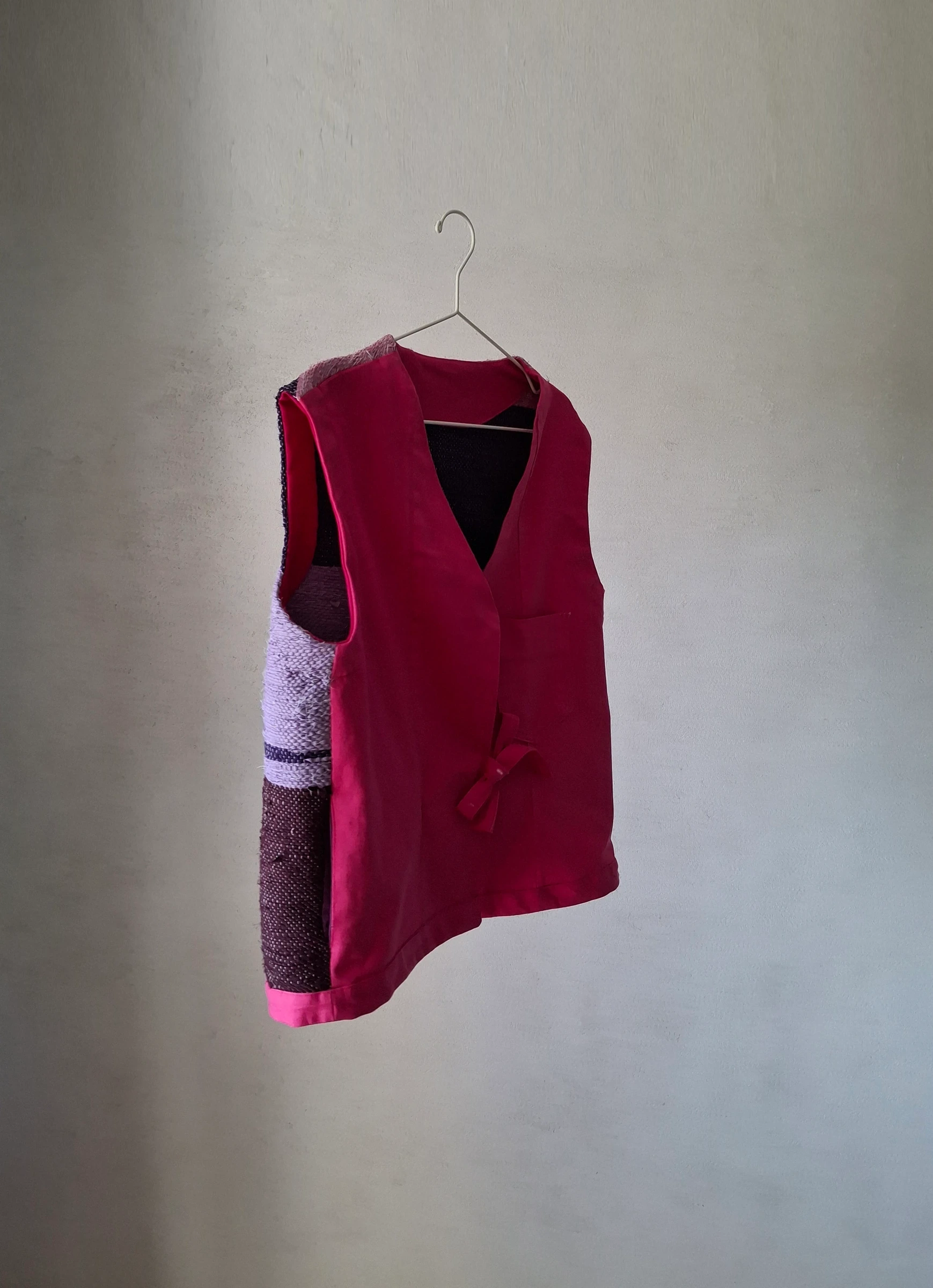 Side view showing the handwoven panel meeting the cyclamen denim front